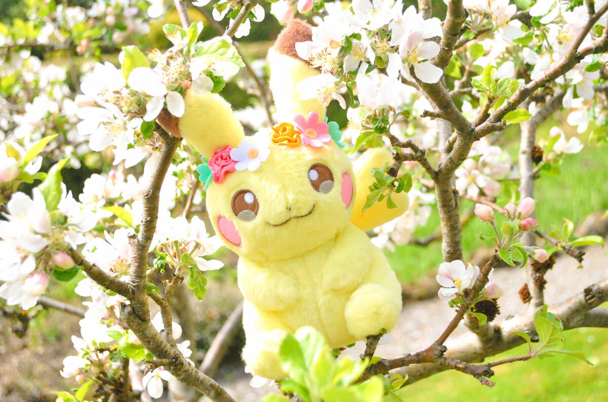 Two anime style figures sitting amongst moss